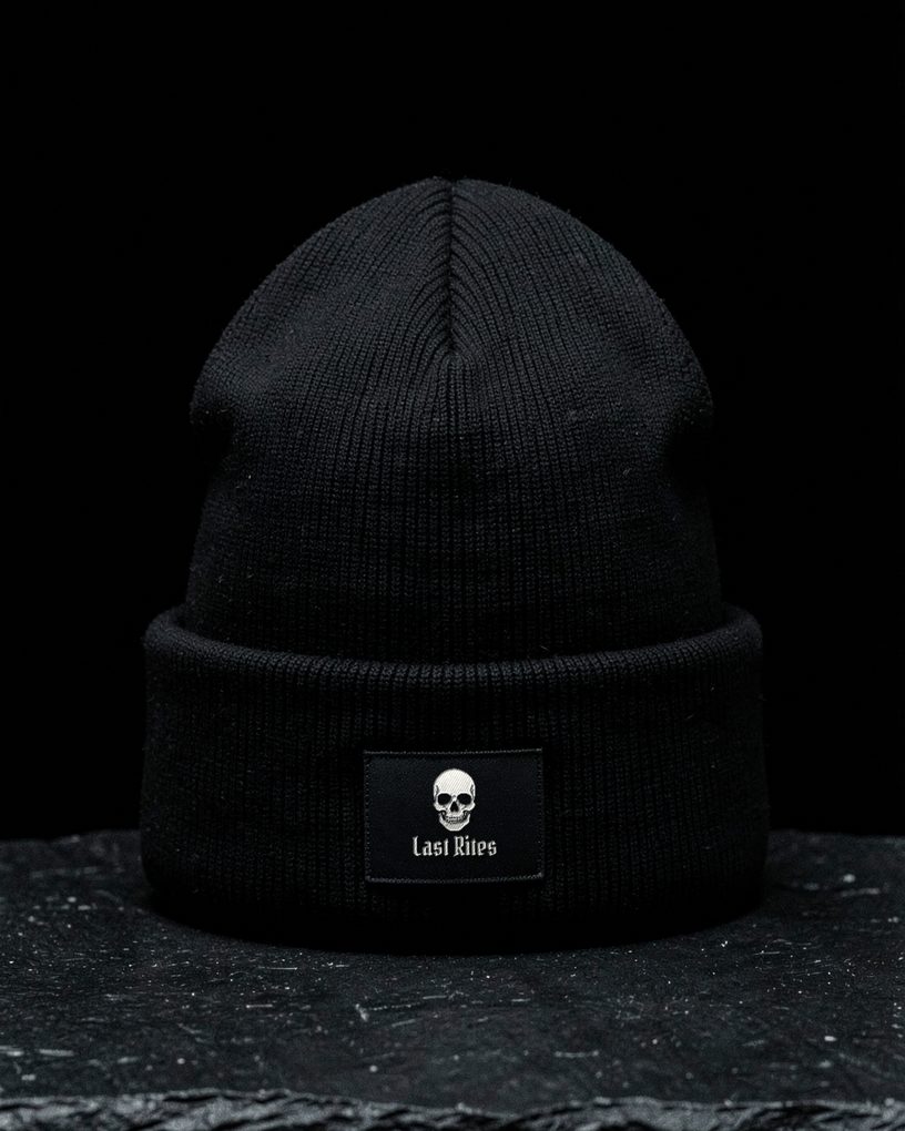 A black ribbed thermal beanie with a small skull label on the cuff.