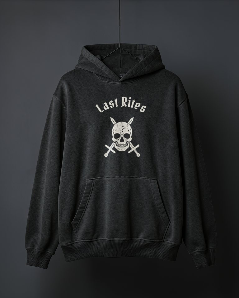 An oversized washed black heavyweight hoodie hanging on a thread with the hood down, printed in cream on the chest with Last Rites arched over the skull and crossed swords.